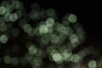 Abstract green bokeh lights on black background