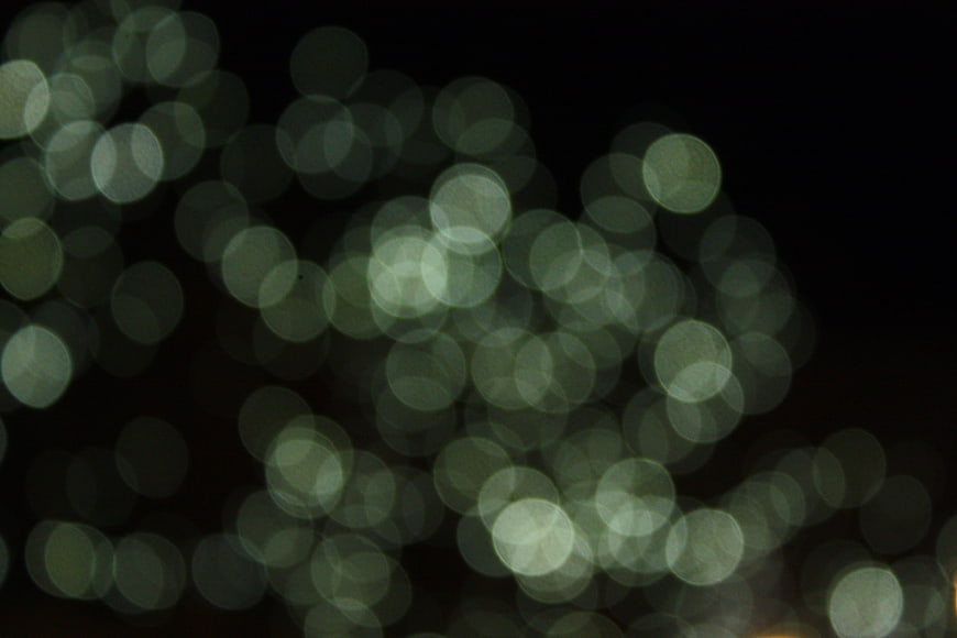 Abstract green bokeh lights on black background