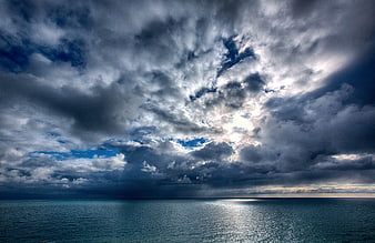 Dramatic Stormy Sky Over Calm Ocean Horizon