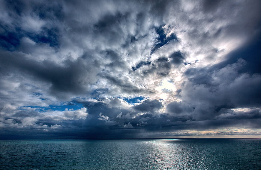 Dramatic Stormy Sky Over Calm Ocean Horizon