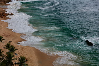 Aerial View of Turquoise Ocean Waves Crashing on Sandy Beach