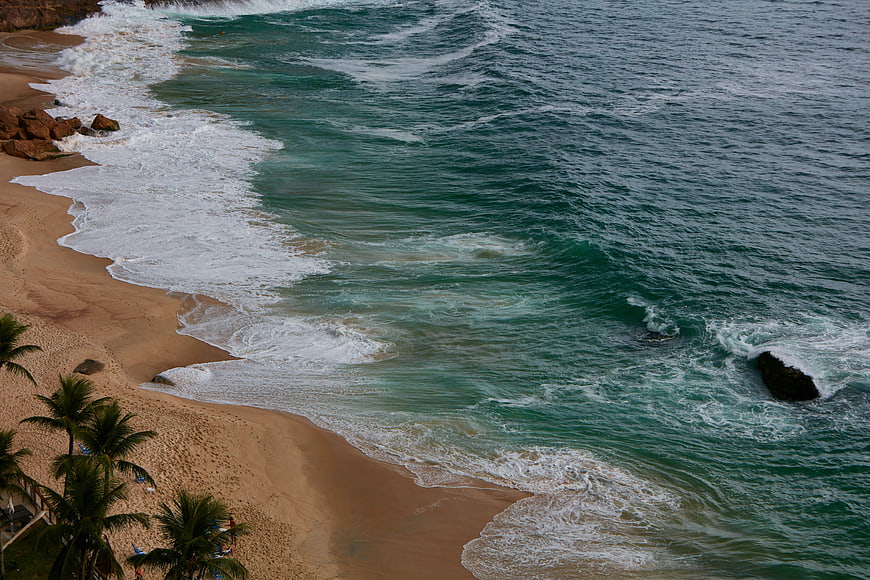 Aerial View of Turquoise Ocean Waves Crashing on Sandy Beach