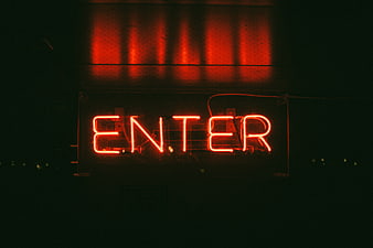Red Neon Enter Sign Glowing in Dark Night
