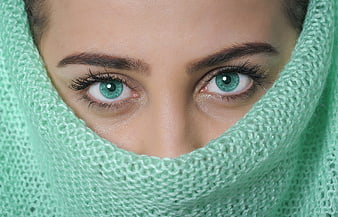 Close-up portrait of woman with green eyes in mint knitwear