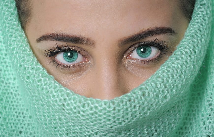 Close-up portrait of woman with green eyes in mint knitwear