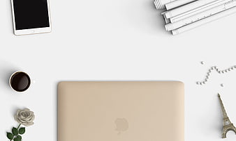 Minimalist beige laptop workspace with coffee and Eiffel Tower