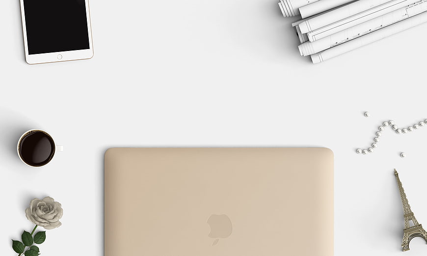 Minimalist beige laptop workspace with coffee and Eiffel Tower