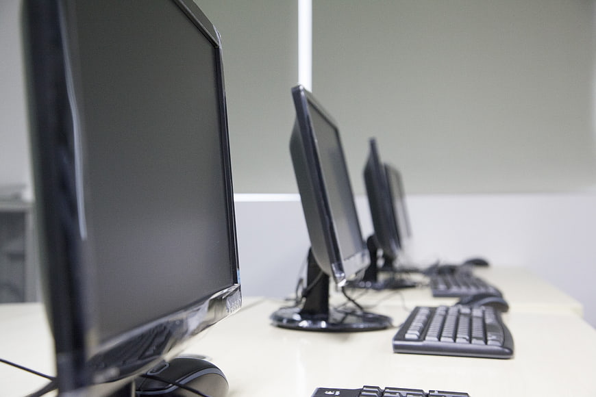 Row of Computer Monitors in a Modern Classroom or Office