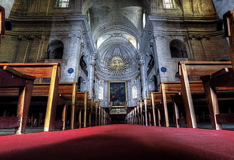 Low angle view of church interior with red carpet aisle