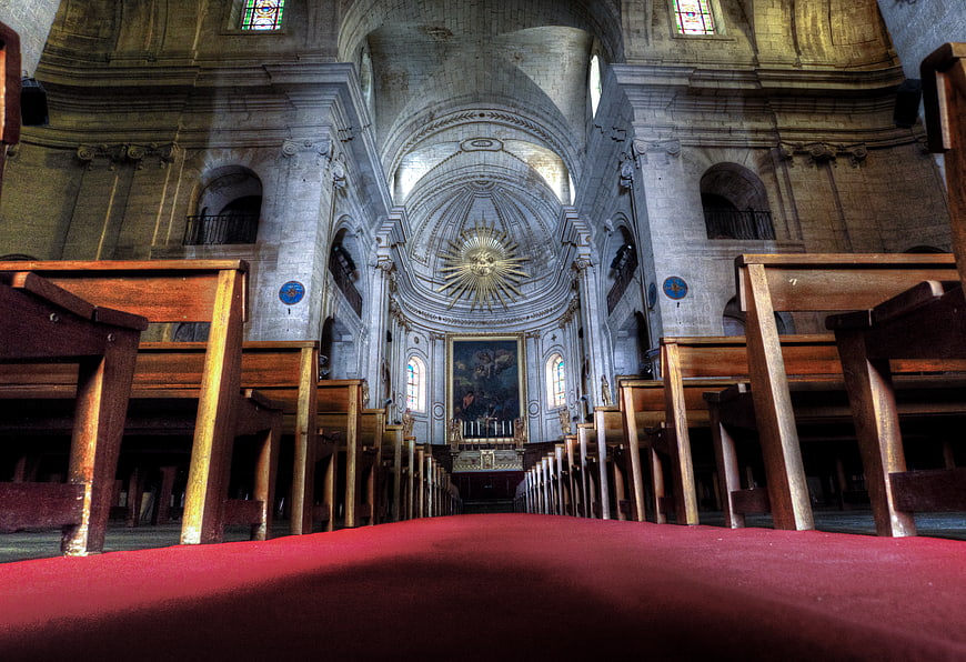 Low angle view of church interior with red carpet aisle