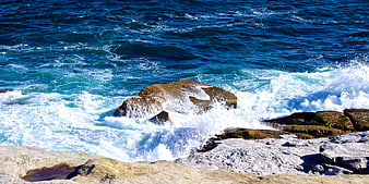 Powerful Ocean Waves Crashing Against Rocky Coastline