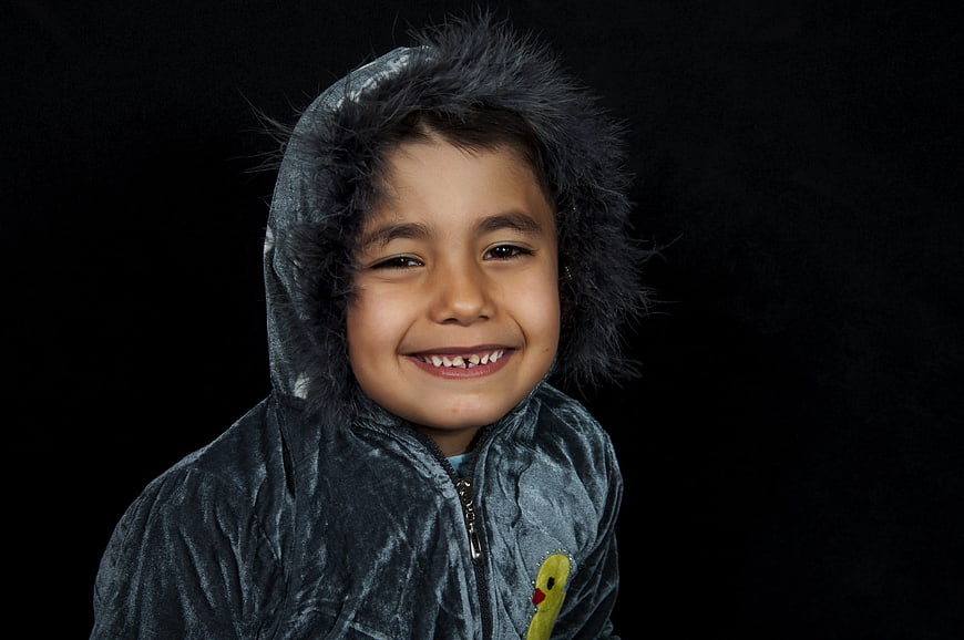 Portrait of a smiling child in a hooded jacket