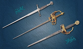 Three antique swords on blue background