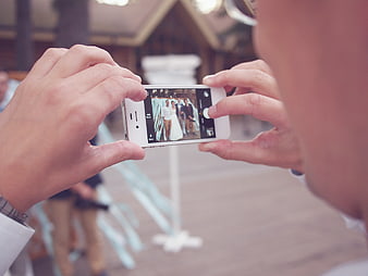 Man taking wedding photo with smartphone camera