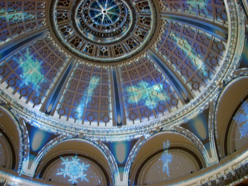Ornate dome ceiling with projected snowflake light patterns