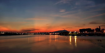 Panoramic Sunset Over Harbor With City Lights and Mountain