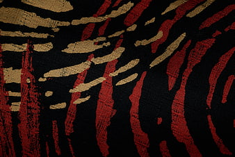 Abstract Red and Gold Brushstroke Pattern on Black Fabric