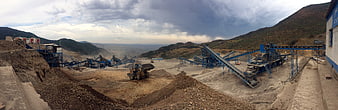 Panoramic view of industrial mining operation with heavy machinery