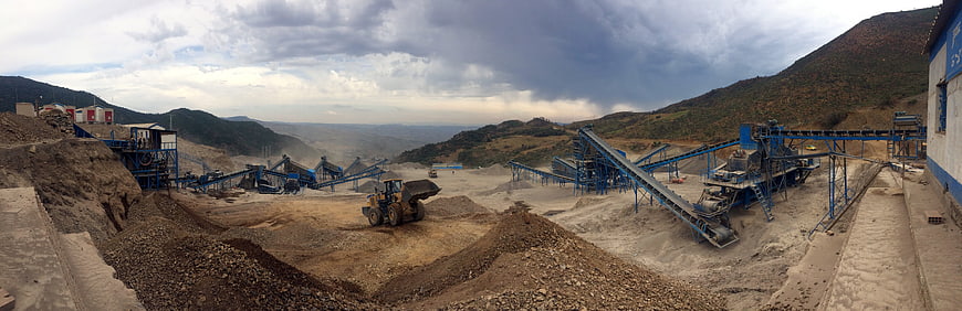 Panoramic view of industrial mining operation with heavy machinery