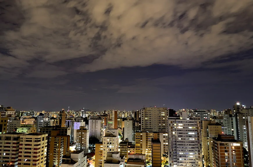 Night Cityscape with Cloudy Sky and Urban Lights