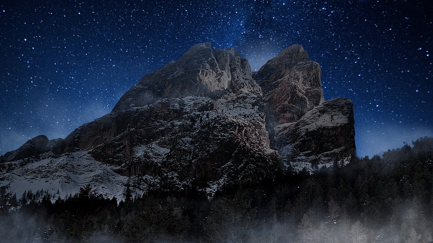 Snowy Mountain Peak Under Starry Night Sky
