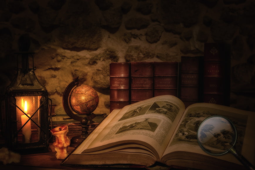 Vintage study still life with old books, lantern, and globe