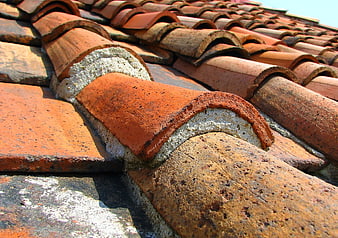 Close-up of weathered terracotta roof tiles with mortar