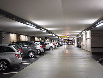 Interior of a modern underground parking garage with cars