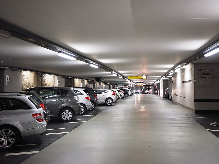 Interior of a modern underground parking garage with cars