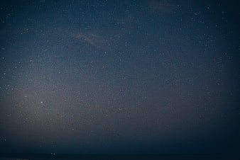 Starry Night Sky Over Dark Ocean Horizon