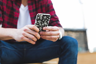 Man in Plaid Shirt Using Smartphone Outdoors