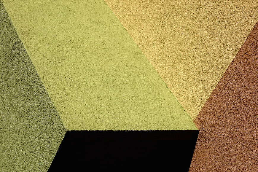 Abstract geometric texture with green, yellow, and brown diagonal stripes