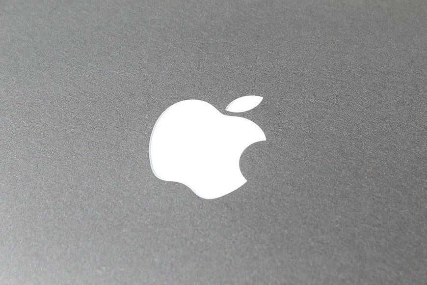 Close-up of Apple Logo on Gray Laptop Surface