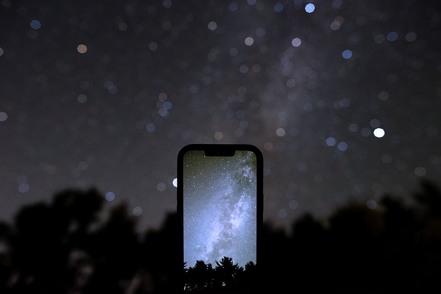 Smartphone displaying Milky Way against night sky