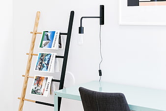 Modern minimalist office corner with magazine rack and desk
