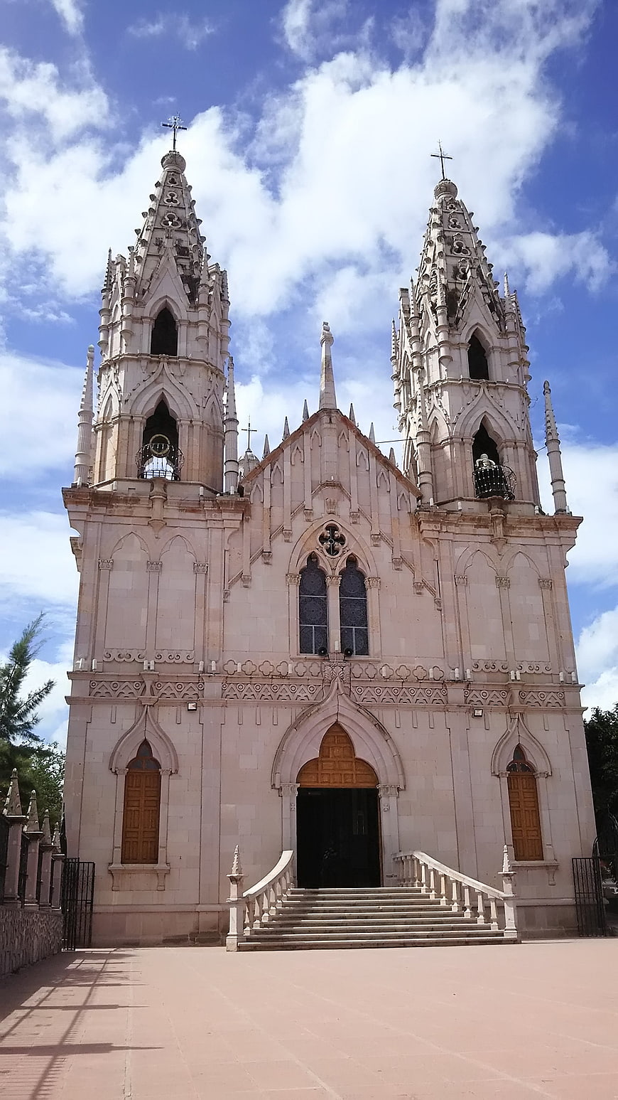 Gothic Revival Church with Twin Spires Under Blue Sky