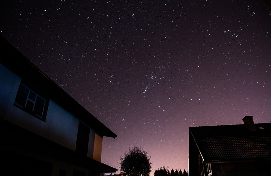 Starry Night Sky Over Residential Houses