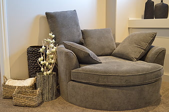 Modern gray swivel chair with cushions in living room