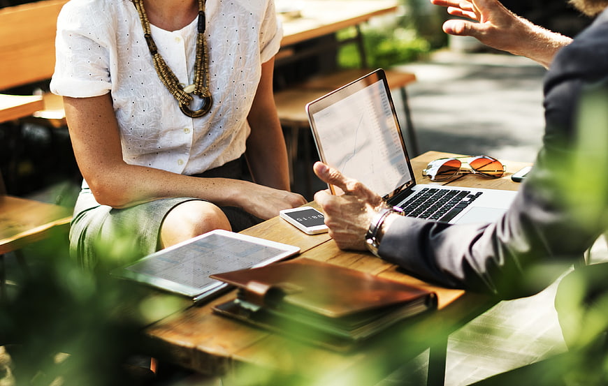 Business meeting outdoors with laptop and tablet