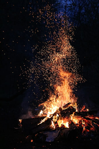Campfire with Sparks Flying at Night