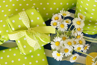 Green Polka Dot Gifts and White Daisies on Blue Striped Table