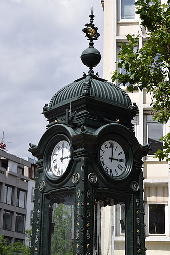 Vintage Green Street Clock Tower in Urban Setting