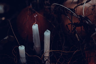 Dark Halloween Candles and Pumpkins in Autumnal Setting