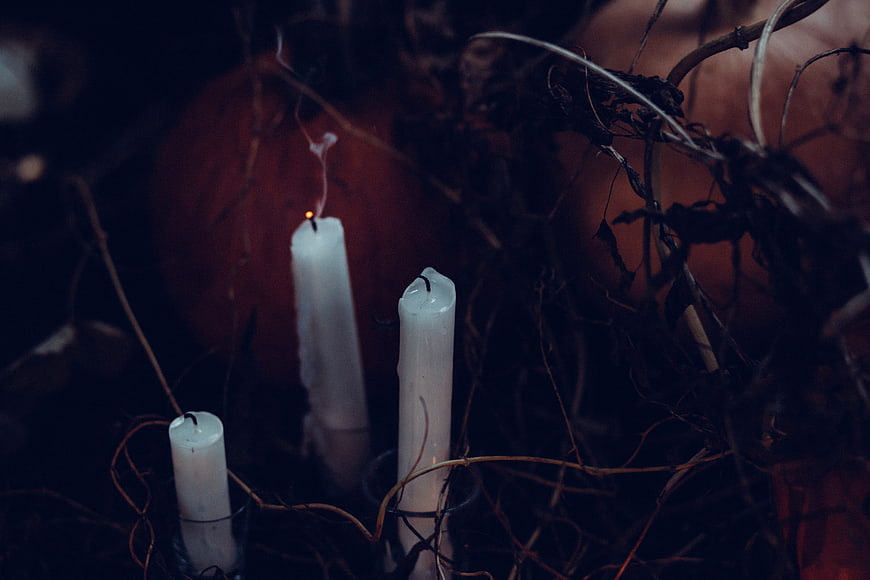 Dark Halloween Candles and Pumpkins in Autumnal Setting
