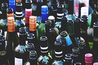 Close-up of colorful wine bottle necks and caps