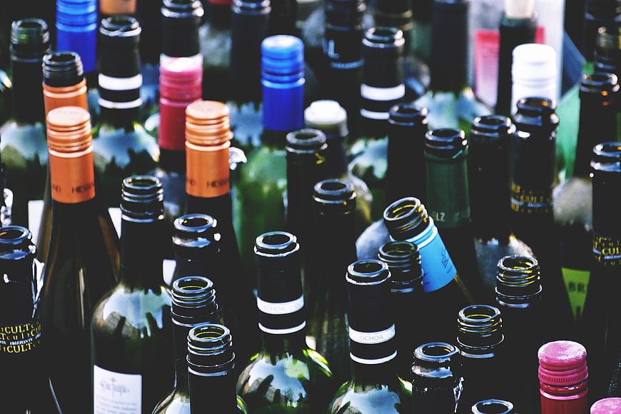 Close-up of colorful wine bottle necks and caps