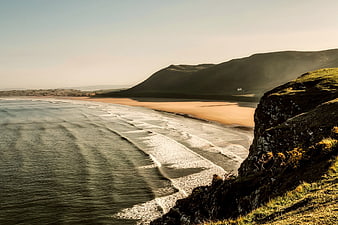 Scenic coastal landscape with rolling waves and sandy beach