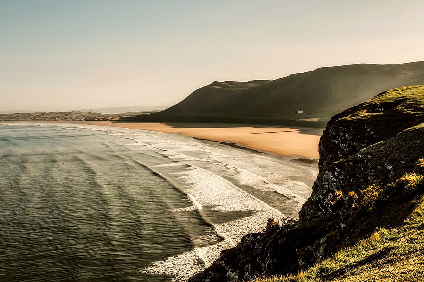 Scenic coastal landscape with rolling waves and sandy beach
