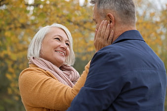 Happy Senior Couple Sharing Intimate Moment in Autumn Park