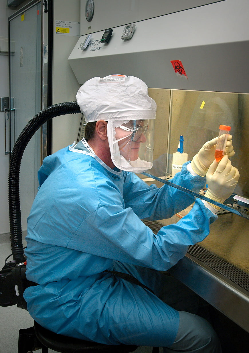 Scientist in protective gear working in a laboratory